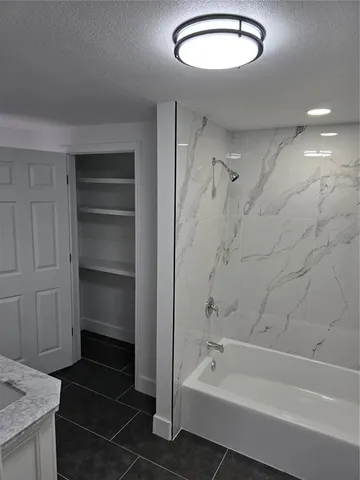 a bathroom with a bathtub and a shower