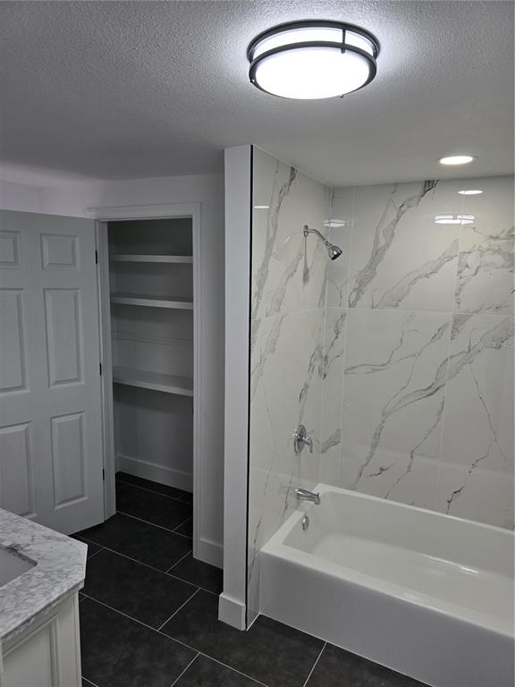 13737 Michelle Avenue Hudson, FL 34667 - Photo 8 of 25 a bathroom with a bathtub and a shower