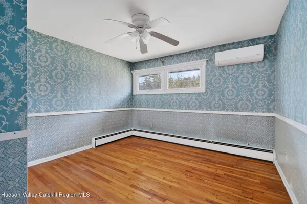 a room with pool table and windows