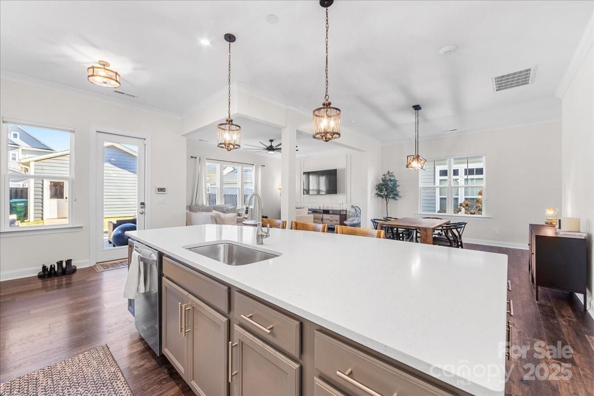 11413 Miller Road Pineville, NC 28134 - Photo 11 of 45 a large kitchen with kitchen island a stove a sink a center island and wooden floor