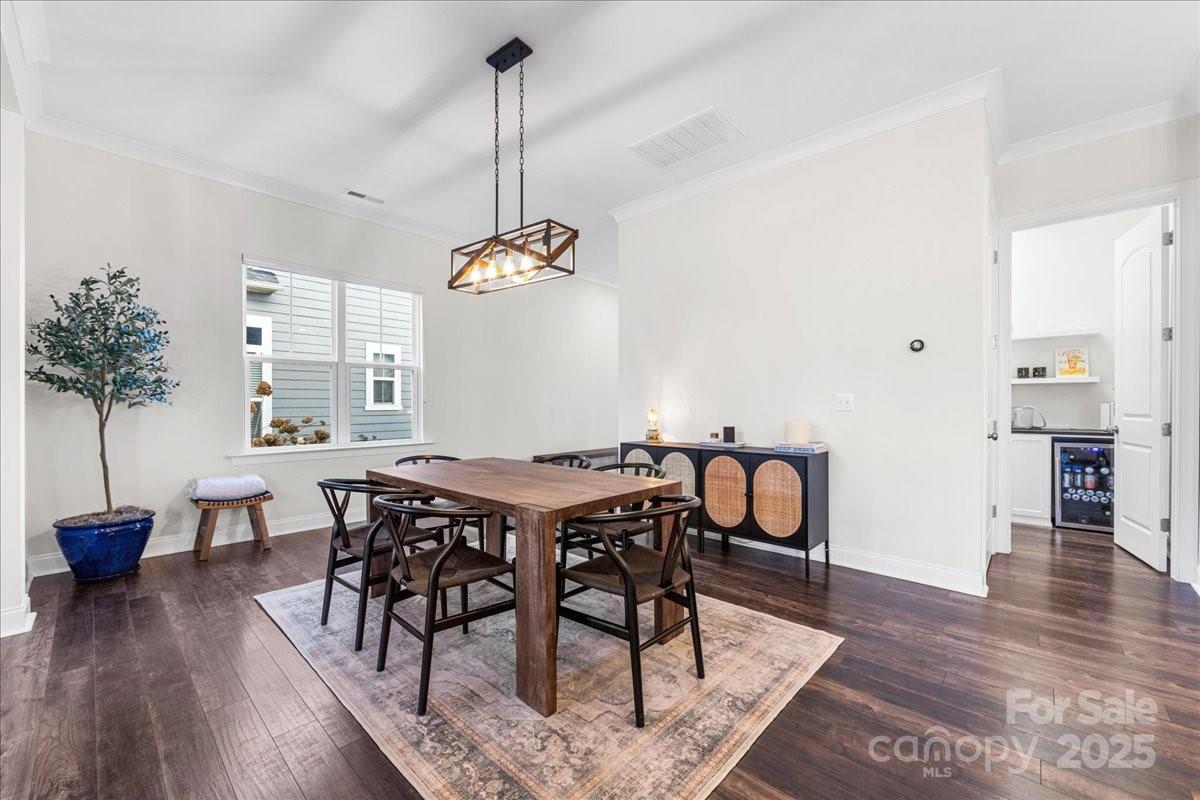 11413 Miller Road Pineville, NC 28134 - Photo 14 of 45 a view of a dining room and livingroom with furniture wooden floor a chandelier
