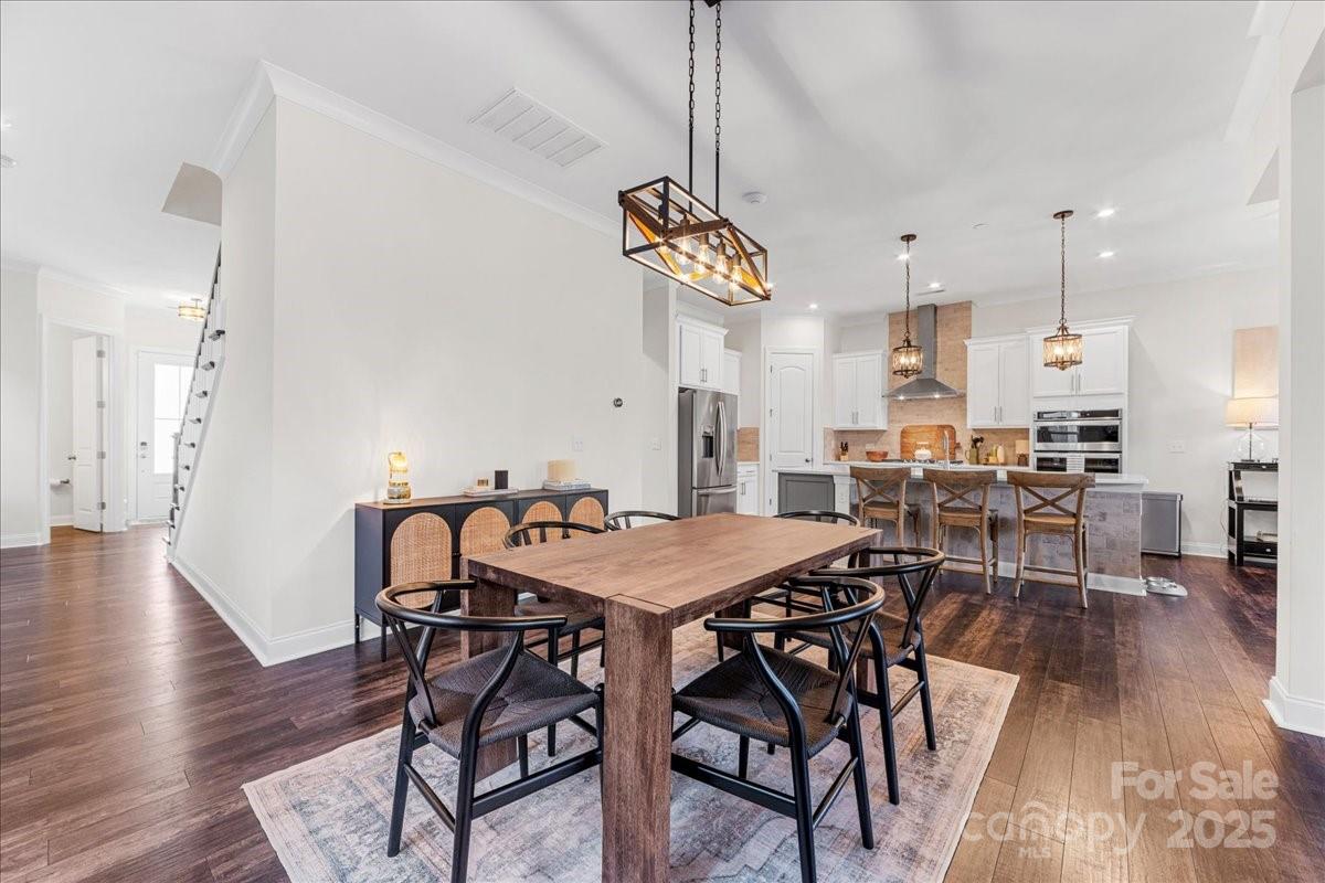 11413 Miller Road Pineville, NC 28134 - Photo 15 of 45 a view of a dining room with furniture and wooden floor