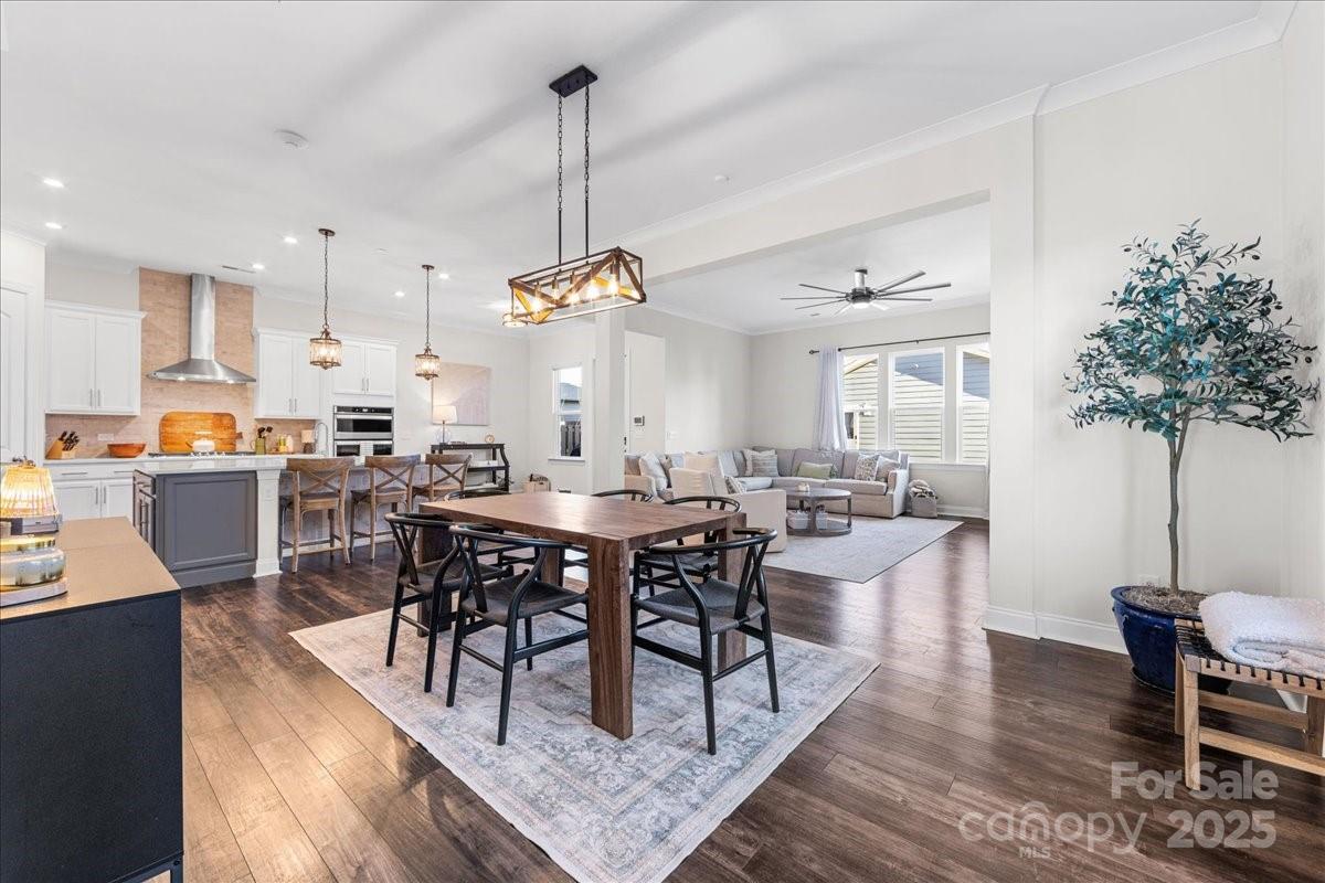11413 Miller Road Pineville, NC 28134 - Photo 16 of 45 a view of a dining room and livingroom with furniture wooden floor a chandelier
