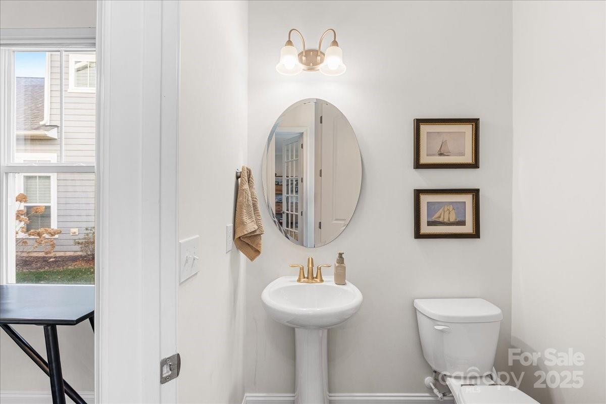 11413 Miller Road Pineville, NC 28134 - Photo 24 of 45 a bathroom with a toilet a sink and a mirror