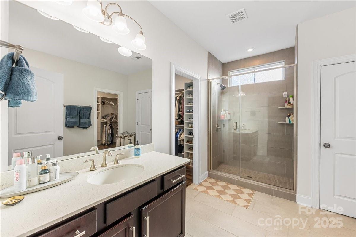 11413 Miller Road Pineville, NC 28134 - Photo 33 of 45 a bathroom with a shower sink vanity and mirror