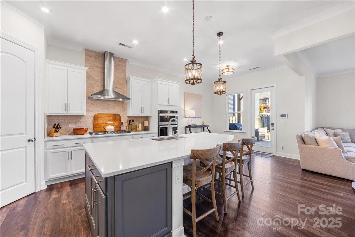 11413 Miller Road Pineville, NC 28134 - Photo 7 of 45 a kitchen with stainless steel appliances a table chairs stove and cabinets