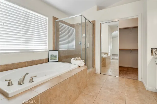 a spacious bathroom with a tub shower and window