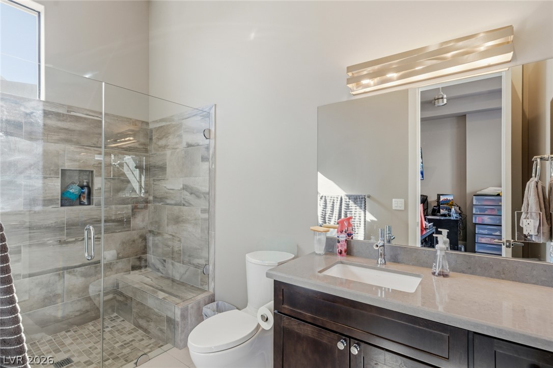 5 Crystal Tree Pass Henderson, NV 89052 - Photo 46 of 67 Sleek vanity with contemporary fixtures anchors this well-appointed bathroom.