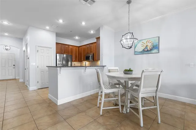 a kitchen with stainless steel appliances granite countertop a stove top oven a refrigerator and a sink