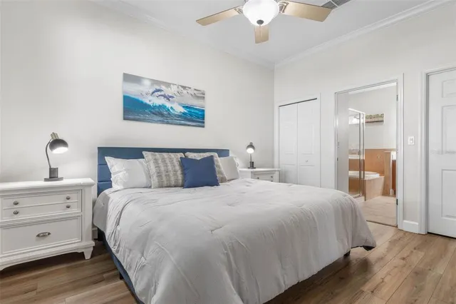 a bedroom with a large bed and a flat screen tv