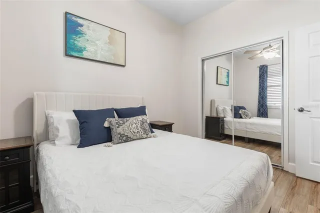 a bedroom with a bed and a chandelier