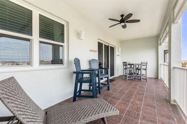 a living room with furniture a rug and kitchen view