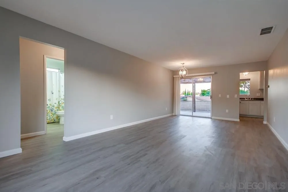 4729 Sunrise Ridge Oceanside, CA 92056 - Photo 3 of 22 a view of an empty room with wooden floor and a window