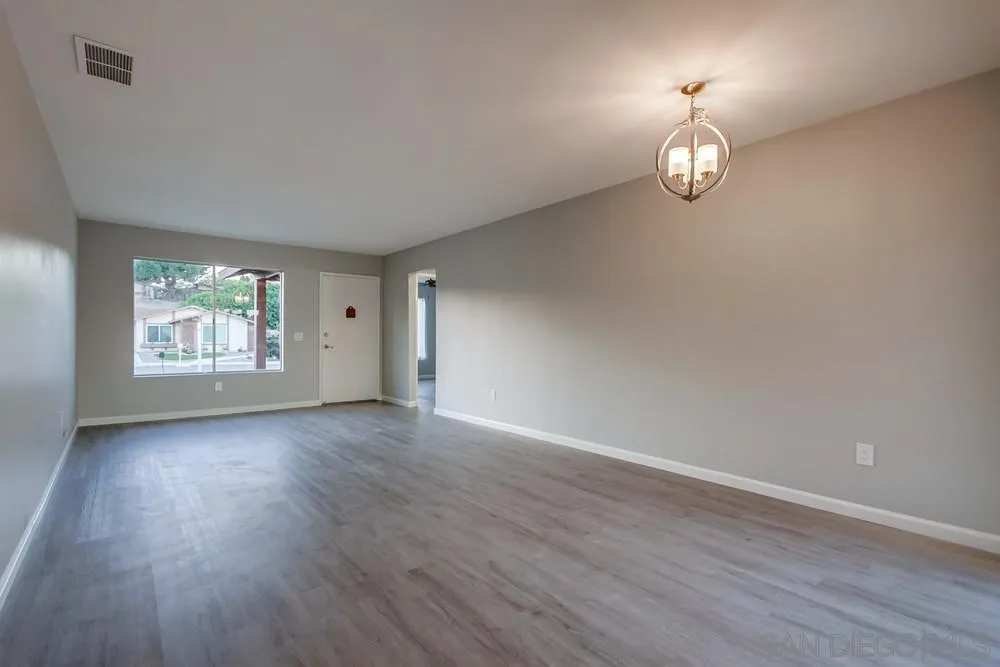 4729 Sunrise Ridge Oceanside, CA 92056 - Photo 4 of 22 an empty room with wooden floor and window
