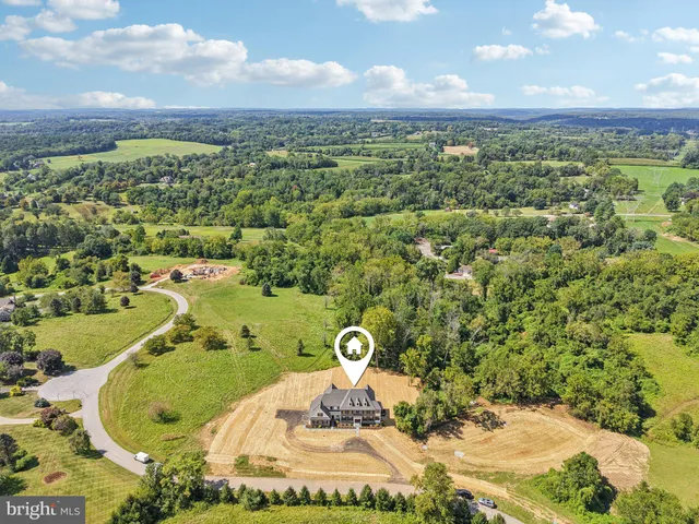 an aerial view of a houses with a yard