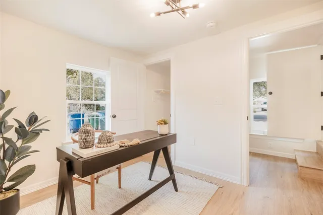 a view of a workspace room with a table and chairs