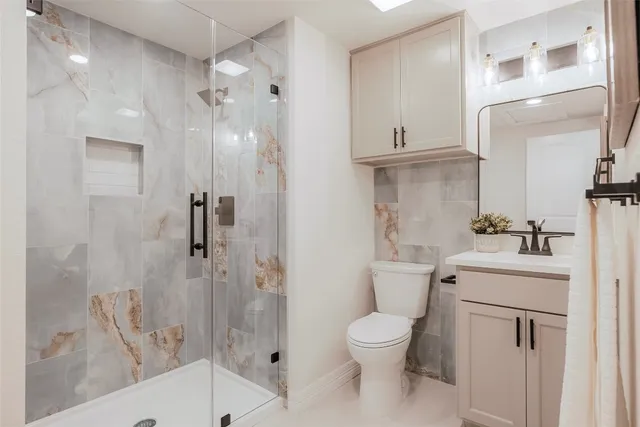 a bathroom with a toilet sink and shower