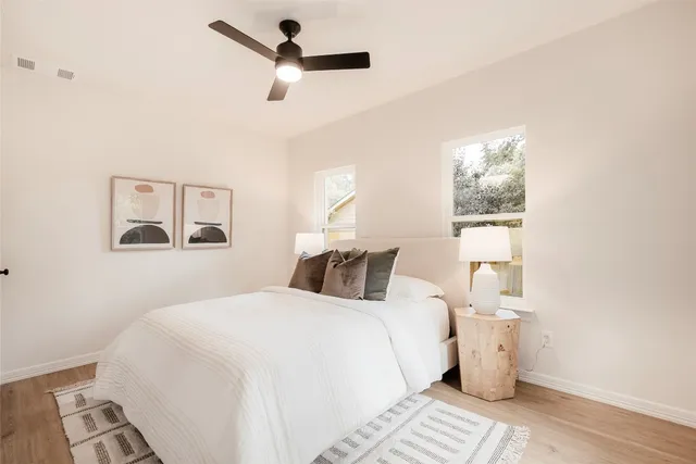 a bedroom with a large bed and a window