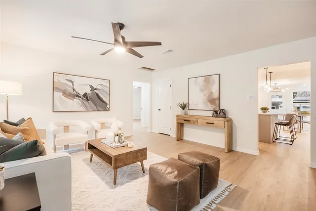 a living room with furniture and kitchen view