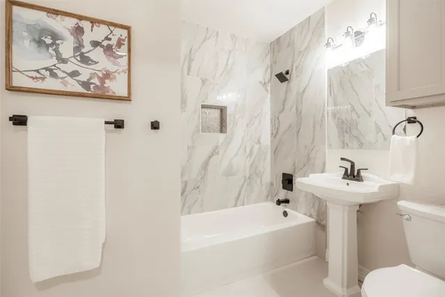 a bathroom with a sink mirror toilet and bathtub