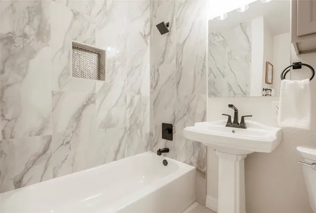 a bathroom with a sink a mirror and a shower