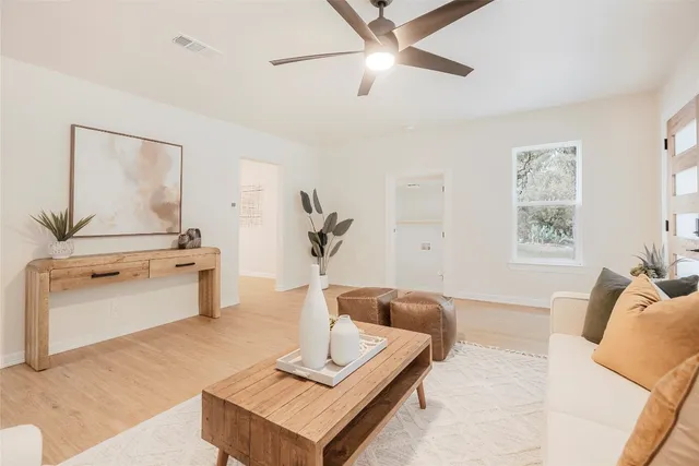 a living room with furniture and a wooden floor