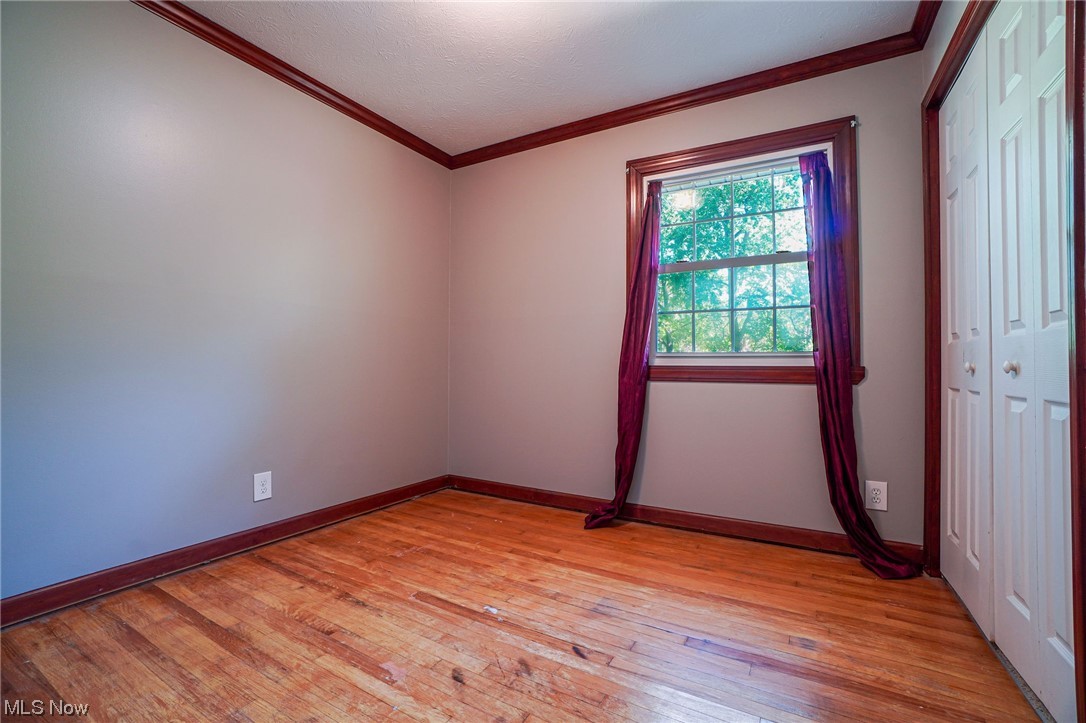 6406 Liberty Road Solon, OH 44139 - Photo 16 of 35 Unfurnished room featuring ornamental molding and light hardwood flooring