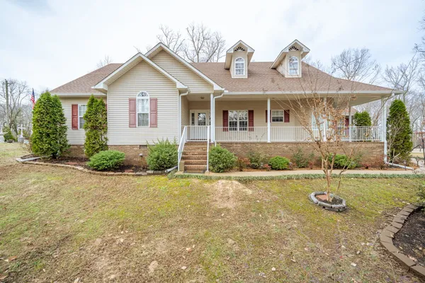 a front view of a house with a yard and porch