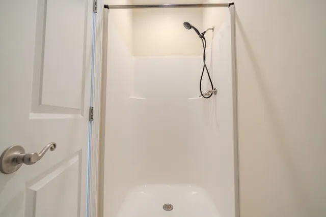 a bathroom with a glass shower door