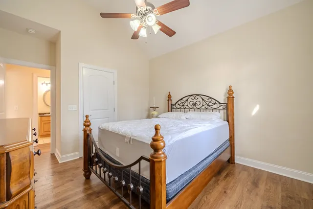 a bedroom with a bed and wooden floor