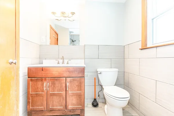 a bathroom with a sink a toilet and window