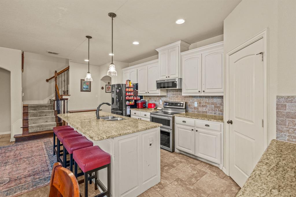 108 Bosque Court Azle, TX 76020 - Photo 15 of 37 a kitchen with white cabinets appliances and furniture