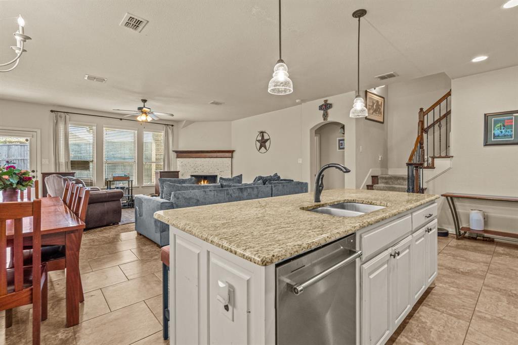108 Bosque Court Azle, TX 76020 - Photo 17 of 37 a kitchen with a stove center island a dining table and chairs