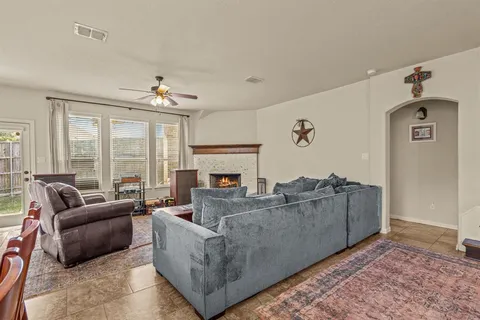 a living room with furniture and a fireplace