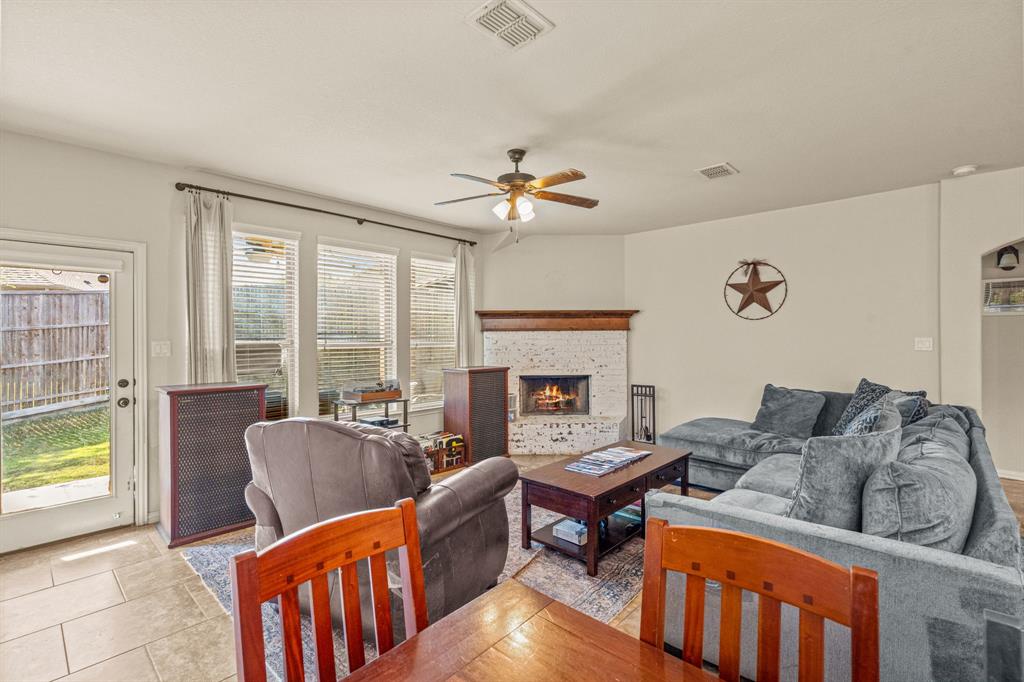 108 Bosque Court Azle, TX 76020 - Photo 22 of 37 a living room with furniture a fireplace and a table