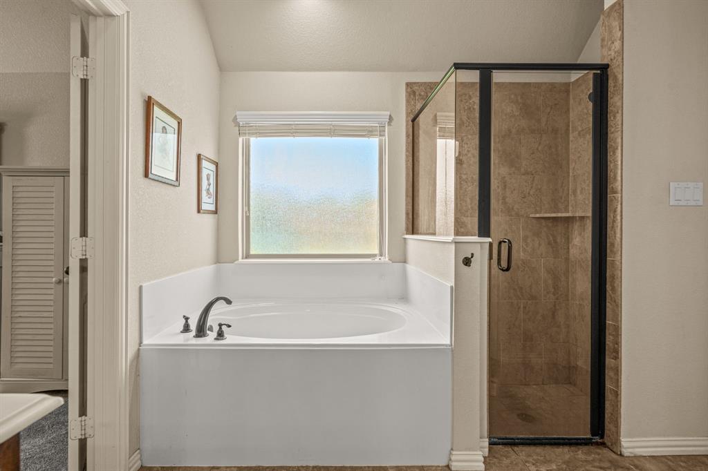 108 Bosque Court Azle, TX 76020 - Photo 25 of 37 a white bath tub sitting next to a shower