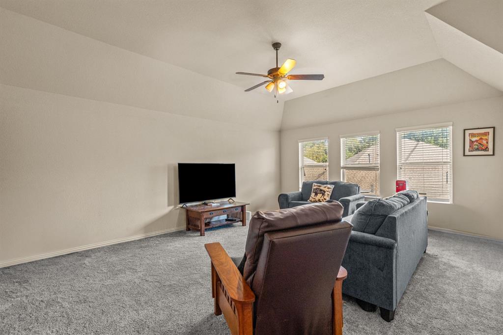 108 Bosque Court Azle, TX 76020 - Photo 26 of 37 a living room with furniture a flat screen tv and a window