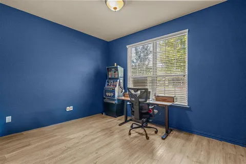a view of a workspace with furniture and a window
