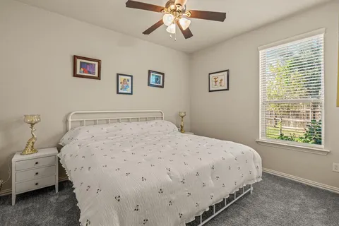 a large bed sitting in a bedroom next to a window