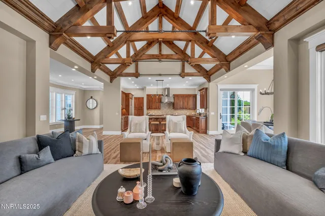 a spacious bedroom with a bed a couch and a chandelier