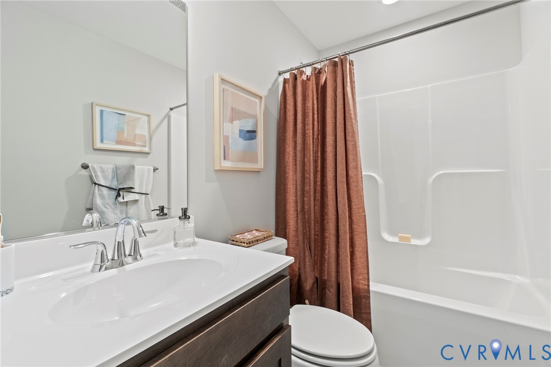 113 Logan Way Tappahannock, VA 22560 - Photo 16 of 33 a bathroom with a sink a toilet and shower