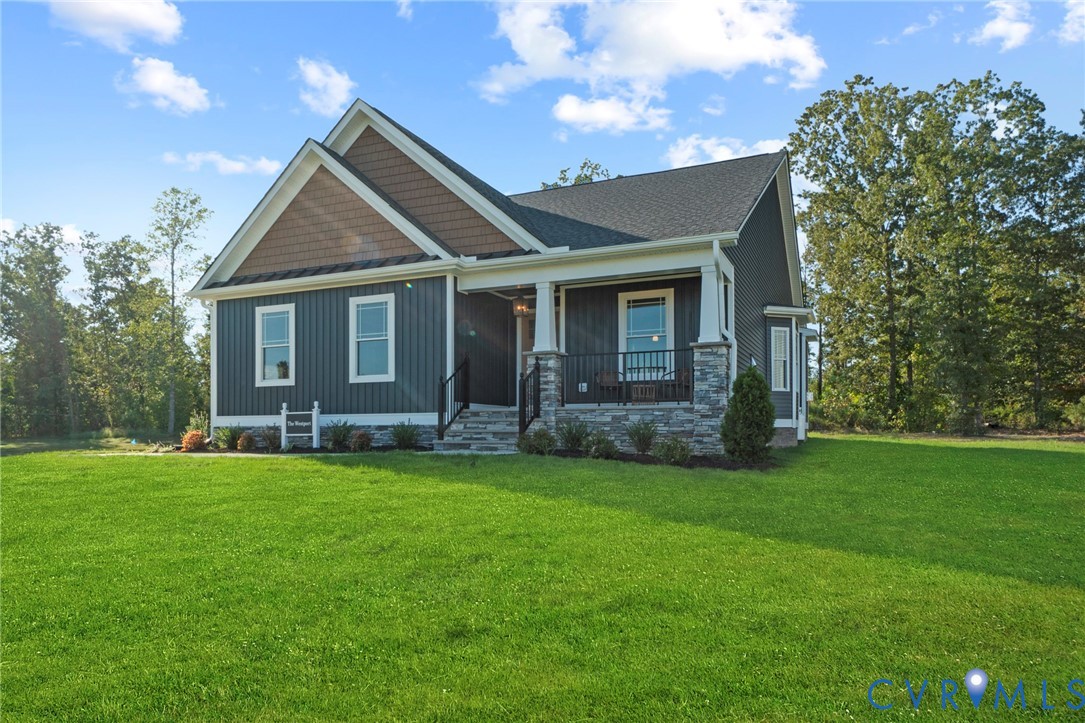 113 Logan Way Tappahannock, VA 22560 - Photo 2 of 33 a front view of a house with a garden
