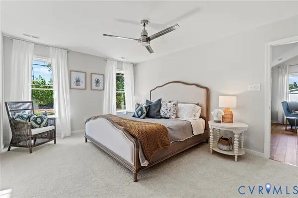 a bedroom with a bed a couch and a window