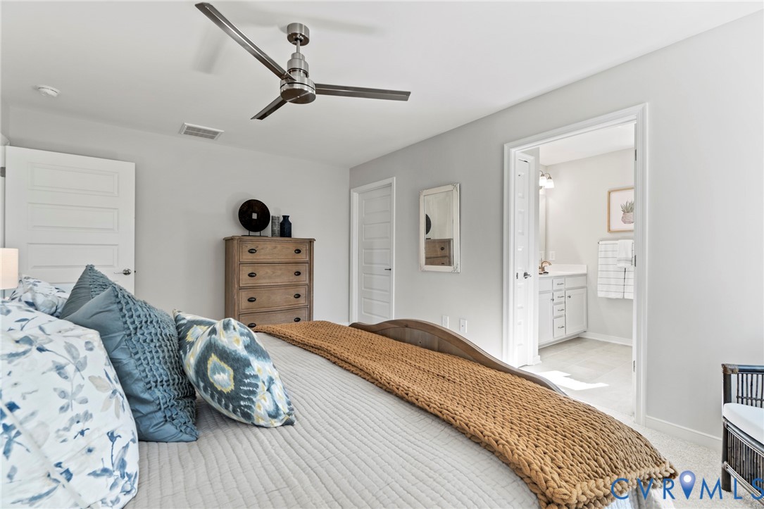 113 Logan Way Tappahannock, VA 22560 - Photo 25 of 33 a bedroom with a bed and wooden floor