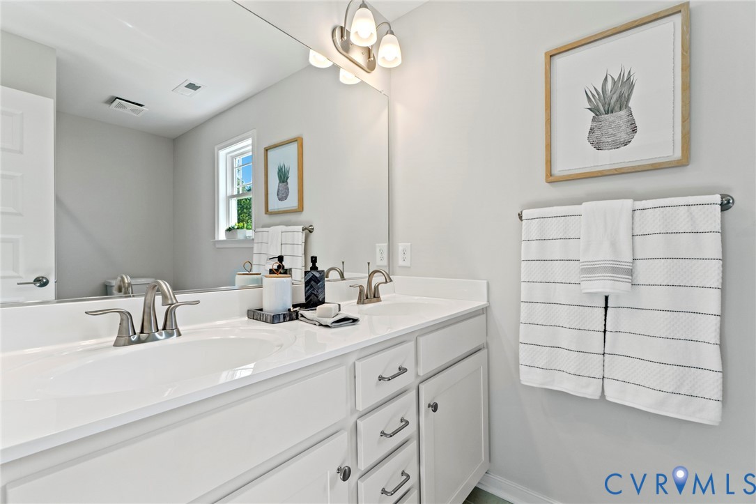 113 Logan Way Tappahannock, VA 22560 - Photo 26 of 33 a bathroom with a sink a vanity and a mirror