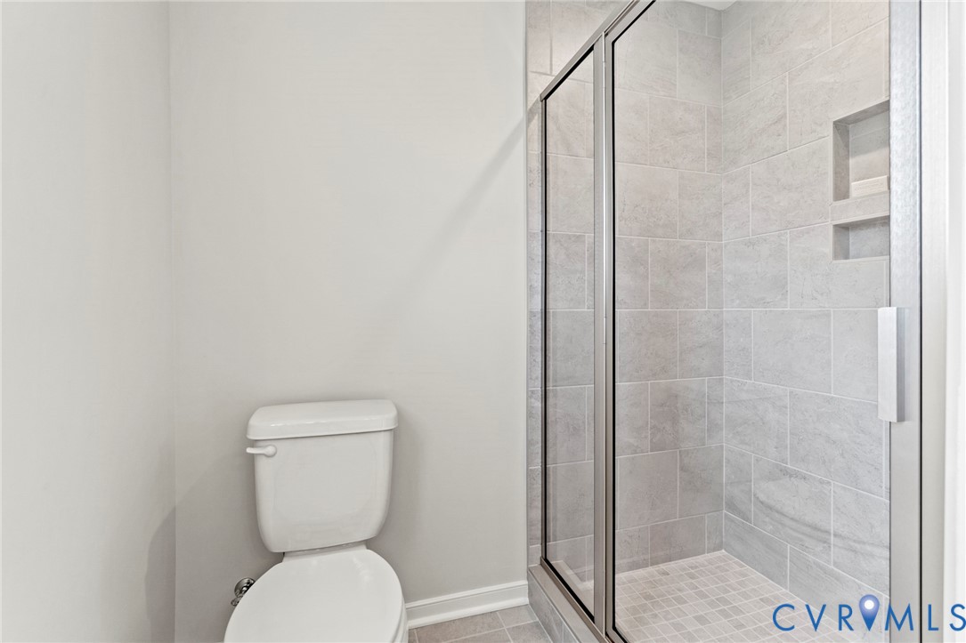 113 Logan Way Tappahannock, VA 22560 - Photo 27 of 33 a white toilet sitting next to a shower