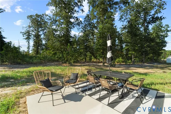 a view of a swimming pool with chair and table and longer chairs