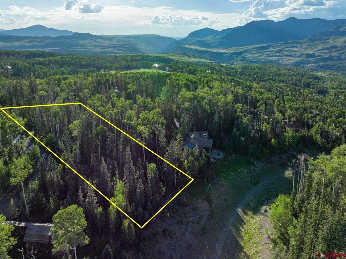 Tbd Lot 333 Benchmark Drive Telluride, CO 81435 - Photo 8 of 22 a view of a green field with mountains in the background