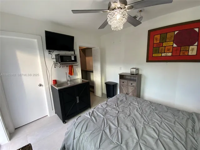 a bedroom with a bed and a flat screen tv