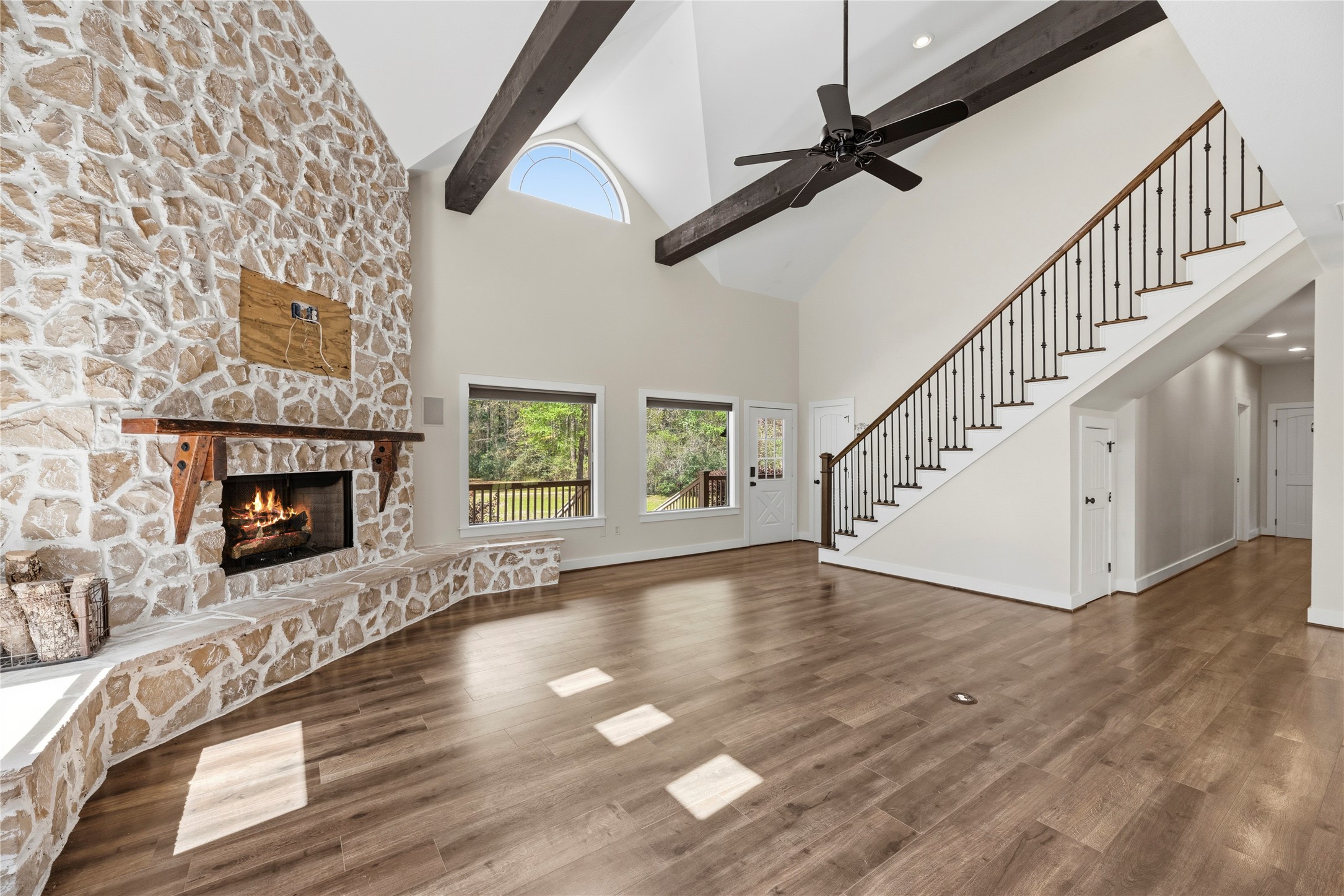 12062 Ike White Road Conroe, TX 77303 - Photo 11 of 37 The family room offers a wood burning fireplace surrounded by a floor-to-ceiling rock wall.